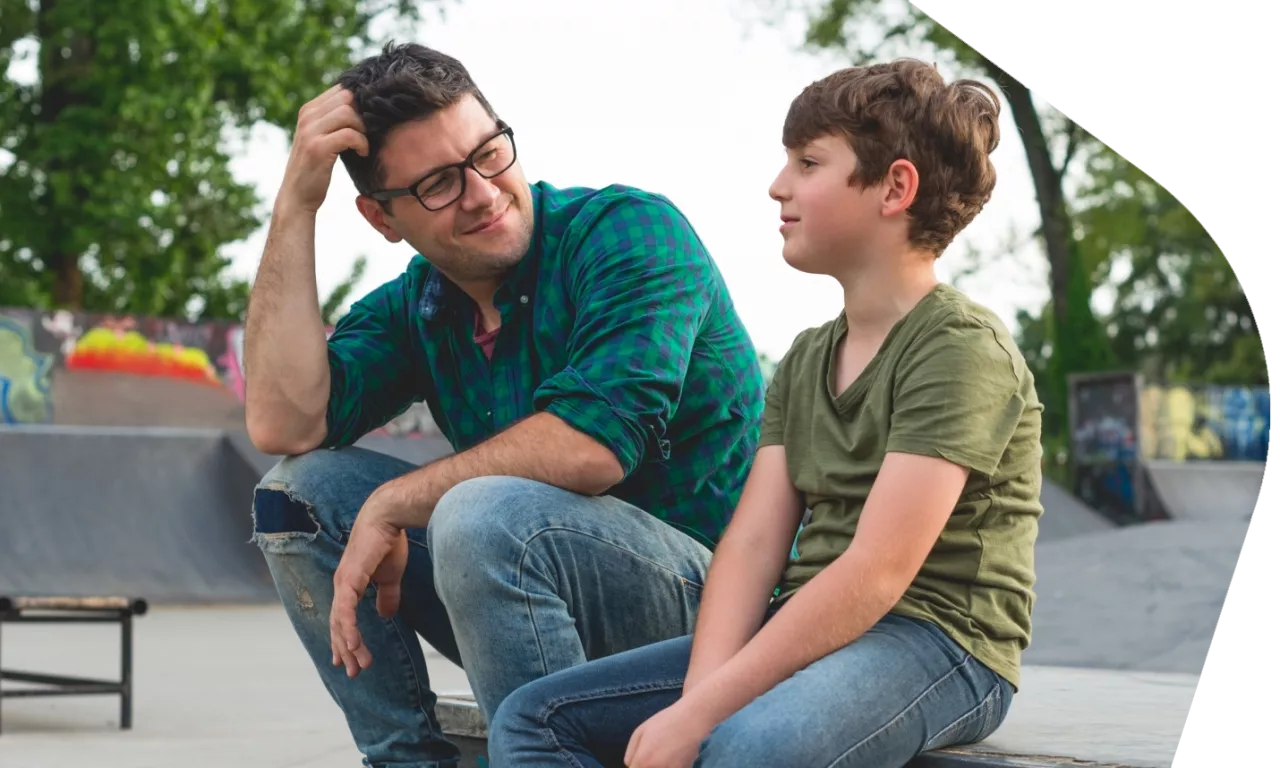 Photo: Father and child sitting in park
