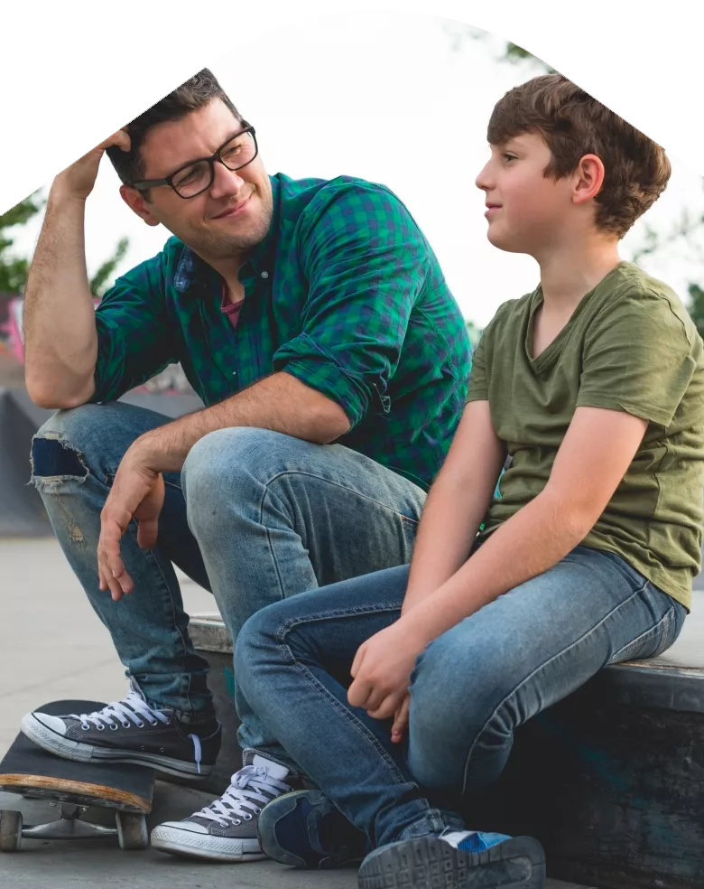 Photo: Father and child sitting in park