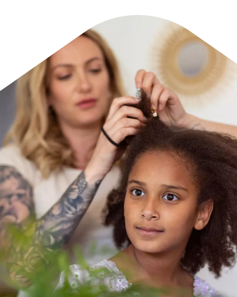 Photo: Mother doing daughter's hair