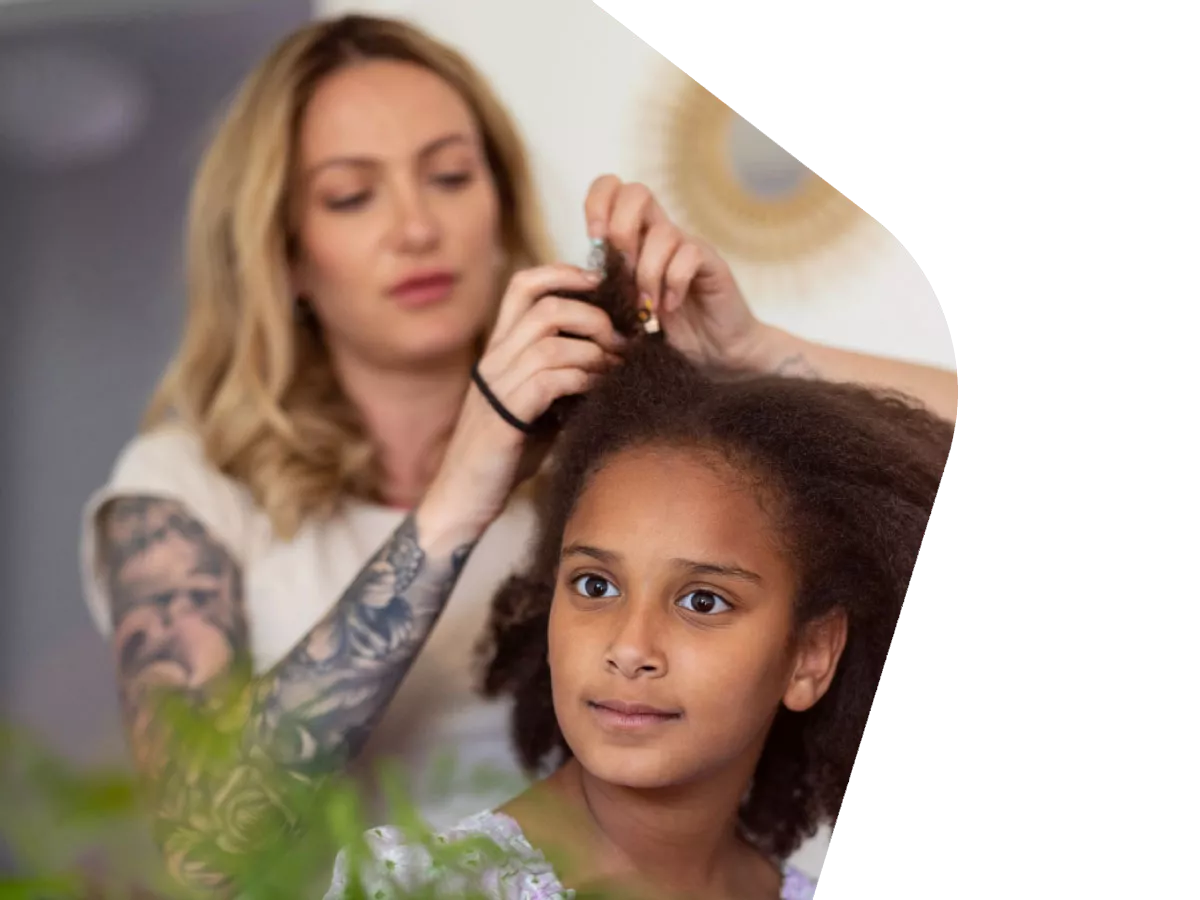 Photo: Mother doing daughter's hair