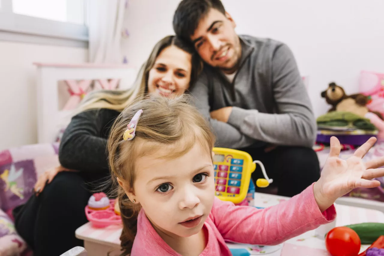 Photo: Parents playing with toddler